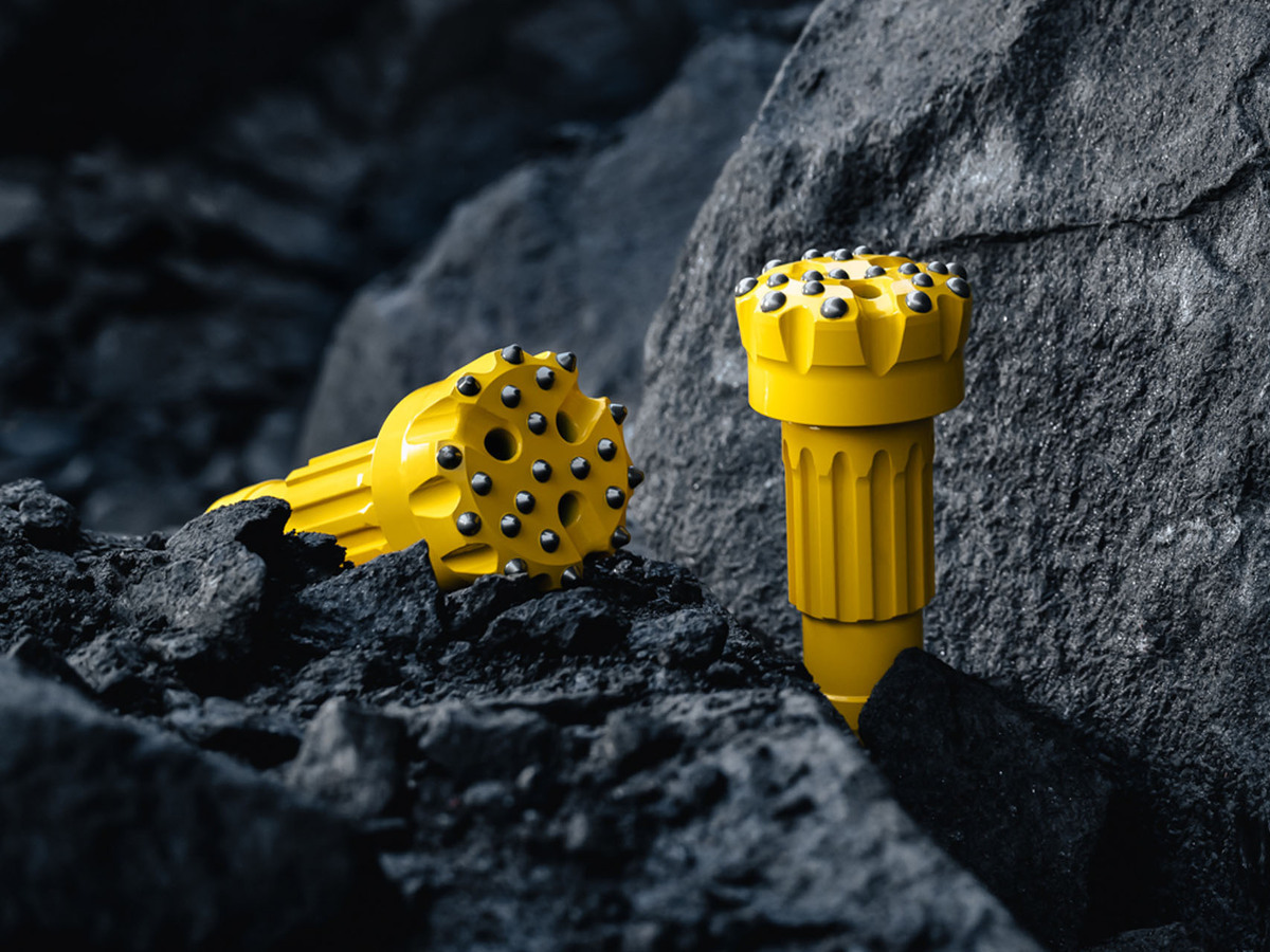 Epiroc DTH drill bits on rocks.jpg